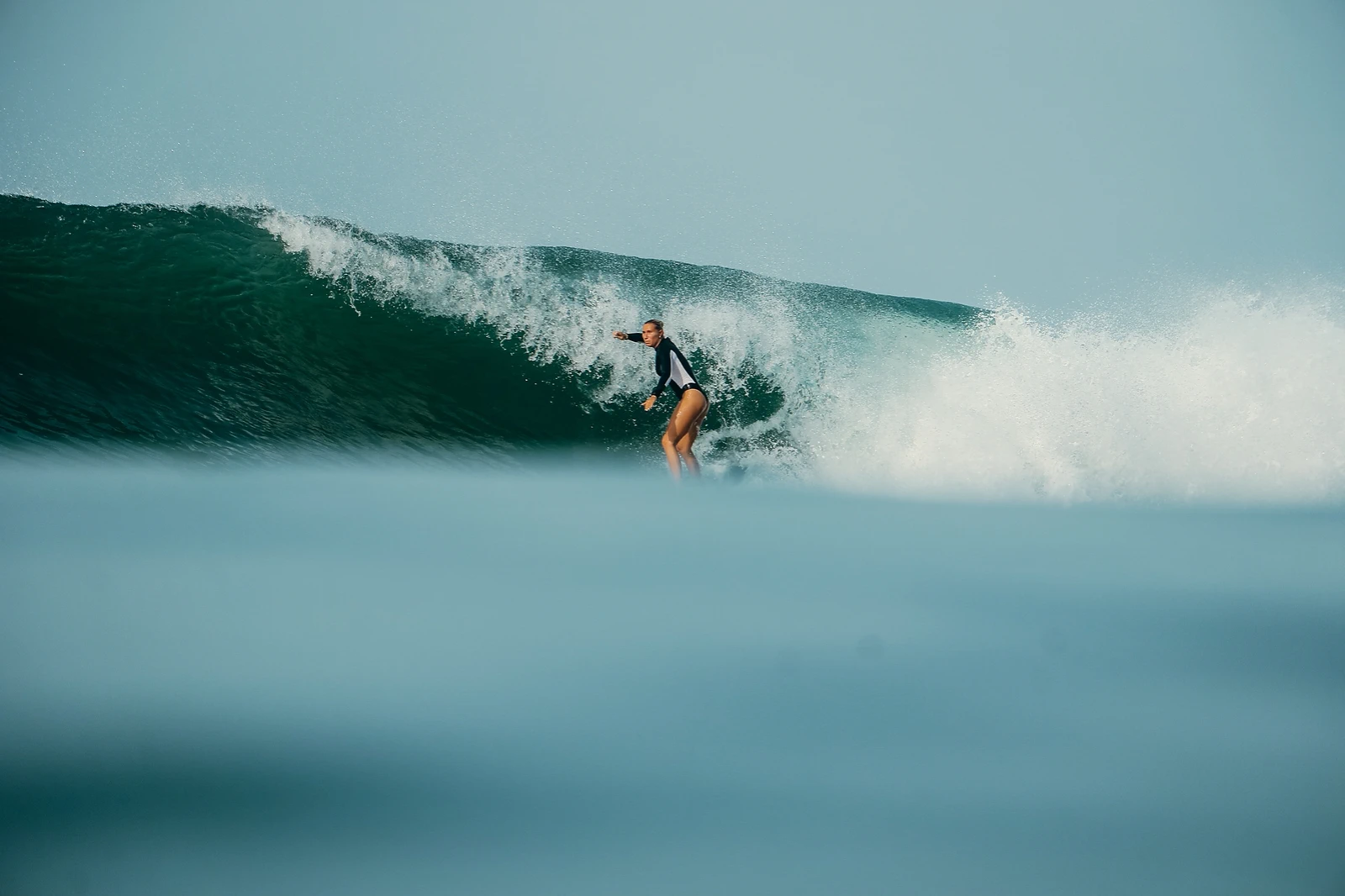 Surfeur surfant une vague tubulaire en formation dans une eau turquoise claire à El Sunzal, El Salvador