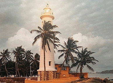 Ahangama lighthouse Cream-colored lighthouse with copper-topped lantern room beside coral keepers cottage at Ahangama, Sri Lanka