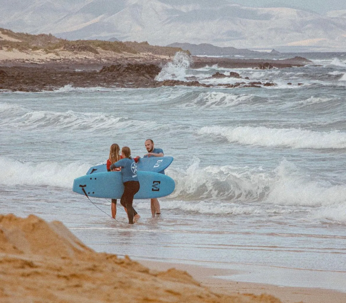International Surf School Camp Fuerteventura beach with palm trees