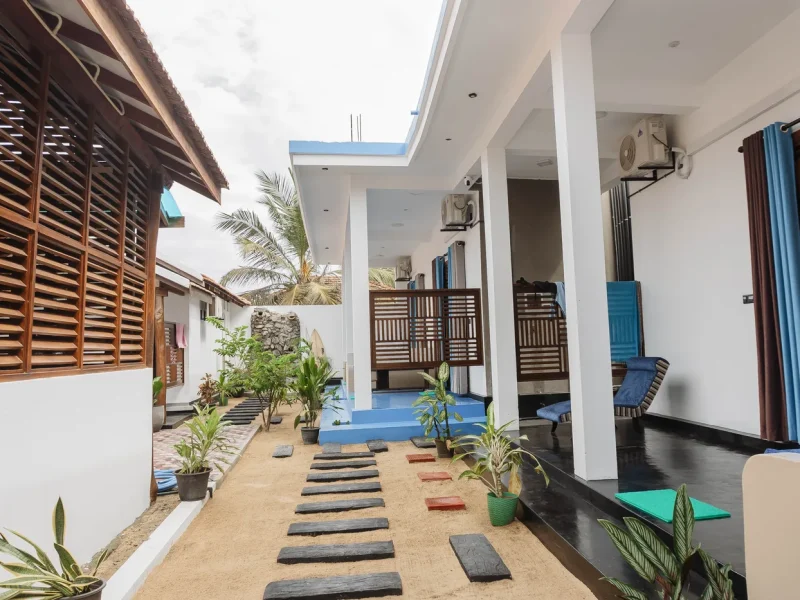 Sand path with stepping stones leading to the private rooms at Wanderlust Surf Camp Arugam Bay