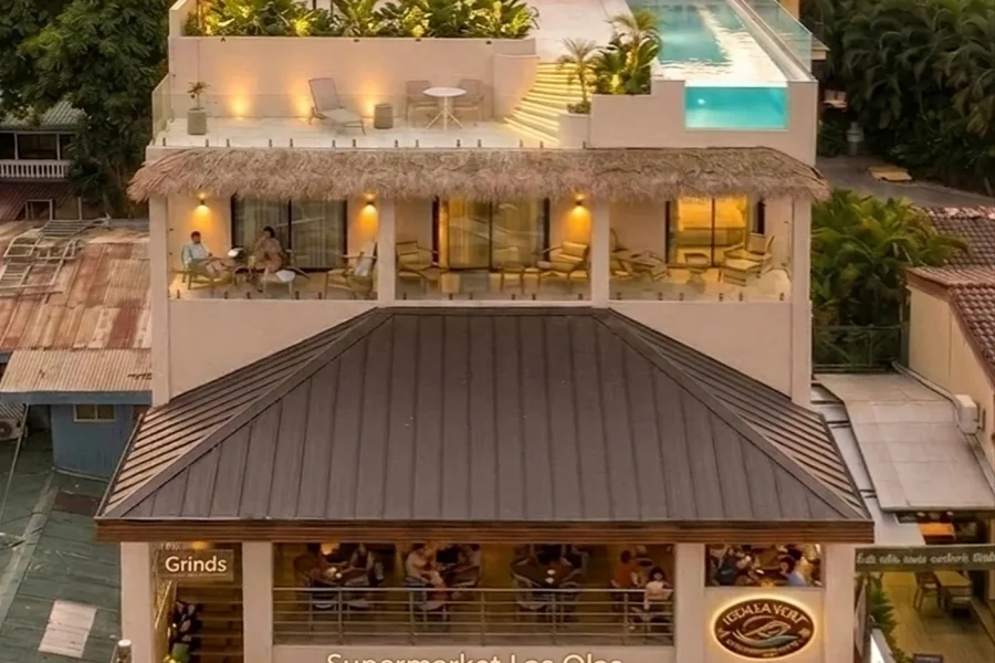 Aerial view of Iguana Surf Boutique Hotel and rooftop infinity pool at dusk in Tamarindo, Costa Rica
